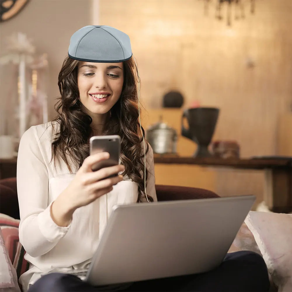 Woman using a red and infrared light therapy and playing with mobile phone.