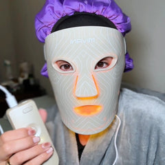 Person wearing a LED face mask with a remote control, featuring the brand 'MIVANI'.