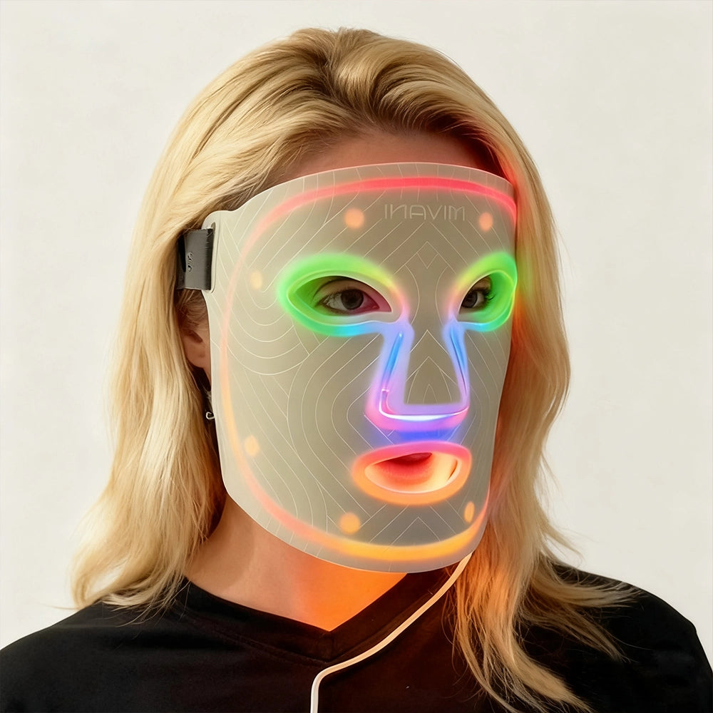 Person wearing a colorful LED face mask against a plain background