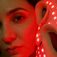 Close-up of a person with a red light and a polka dot object in the foreground