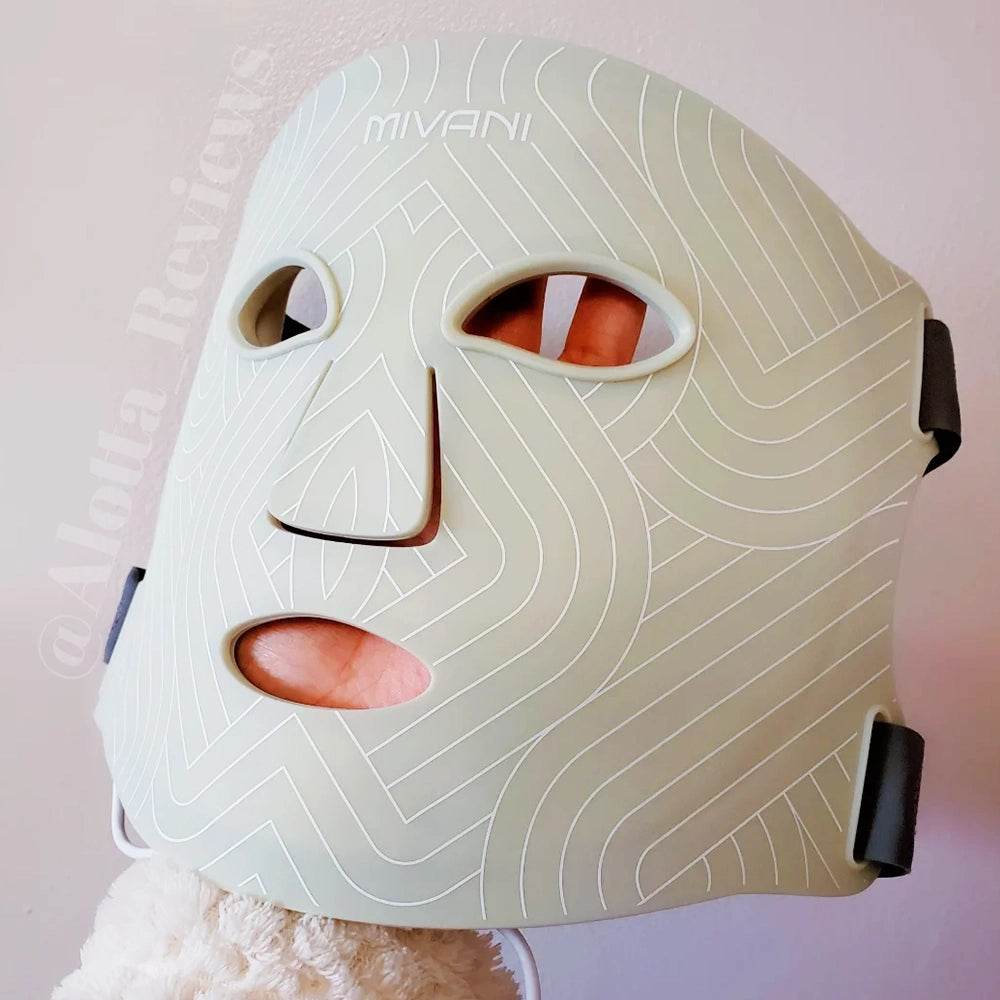 Close-up of a person's face with a red light effect and a polka dot lamp in the foreground.
